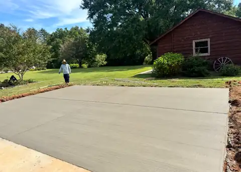 New concrete driveway on a country property at golden hour