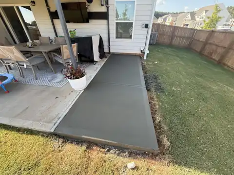 Concrete patio extension beside outdoor furniture