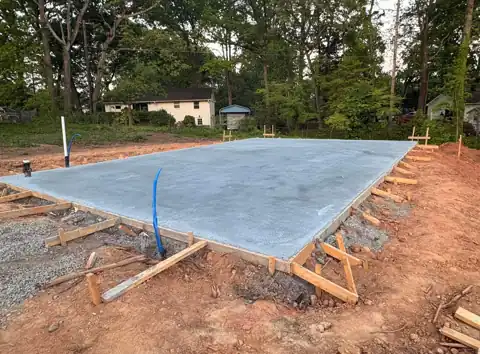 Finished concrete building slab on a wooded lot