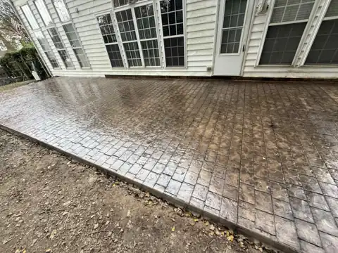 Stamped cobblestone concrete patio at a colonial home
